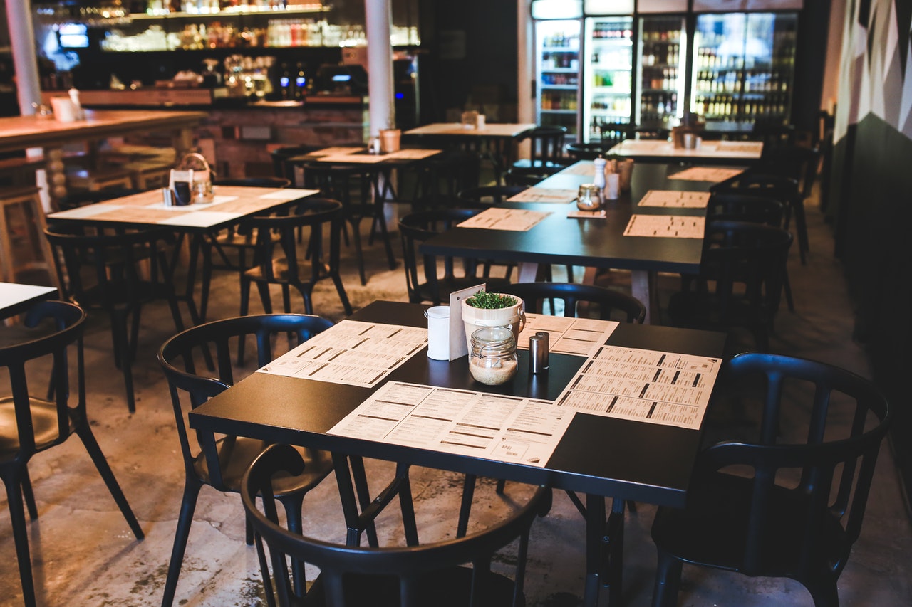 Vintage-style restaurant table set for dining, surrounded by wooden chairs